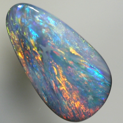 SOLID SEMI BLACK OPAL Red and orange sparkle over a green blue background